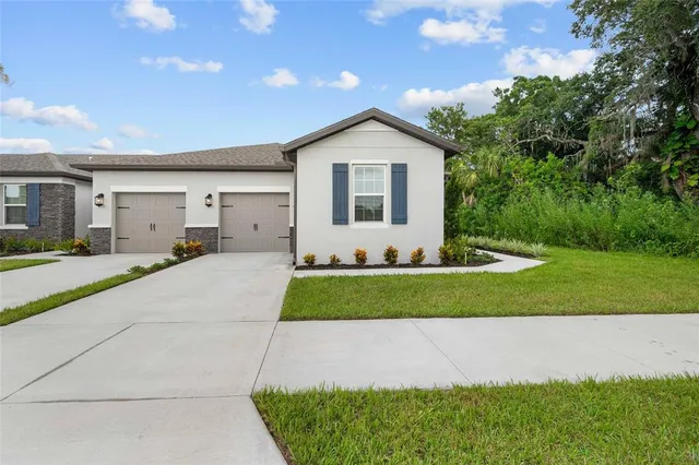a front view of a house with a yard and garage