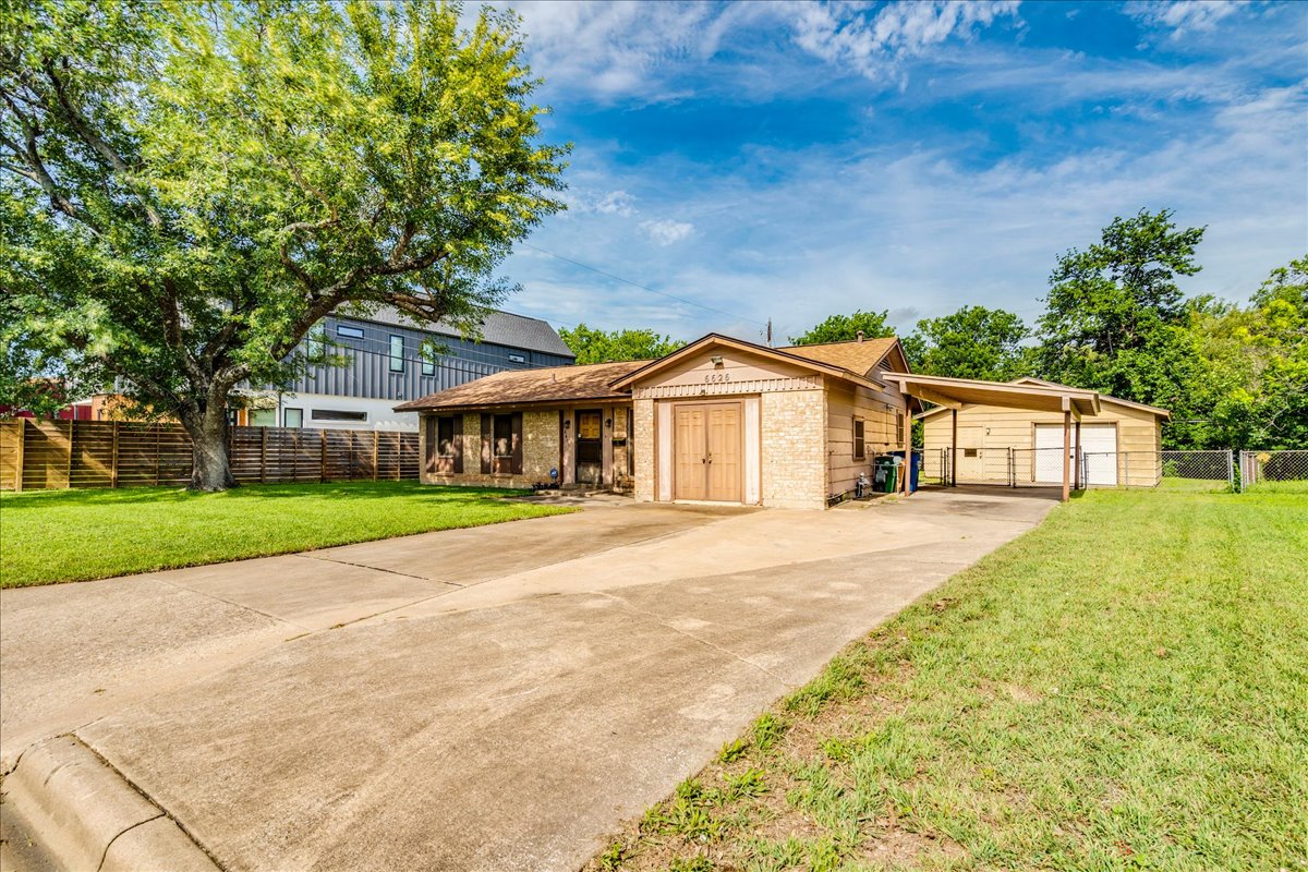 6626 Isabelle Drive Austin, TX 78752 - Photo 5 of 27 Single-story residence featuring a detached two-car carport, and a separate storage structure
