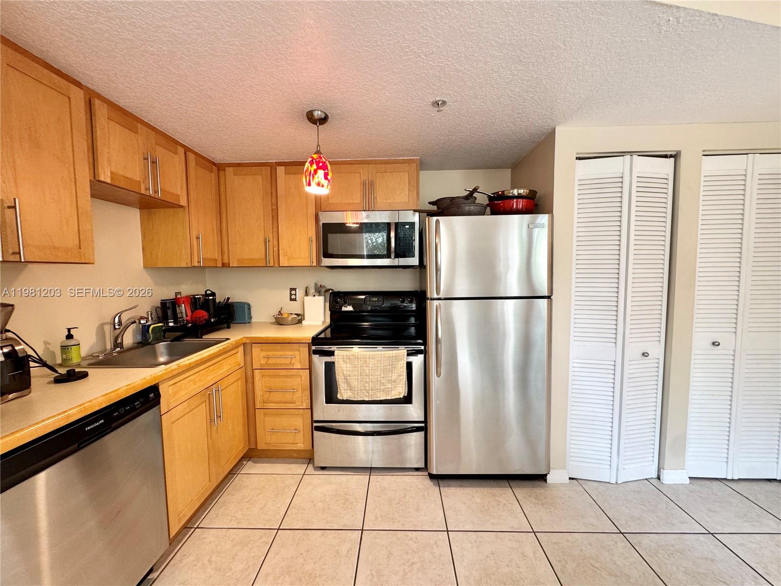 2630 Southwest 28th Street, Unit 1 Miami, FL 33133 - Photo 12 of 33 L-Shaped Kitchen opens to dining/living room making entertaining guests flow. Extra storage closet.