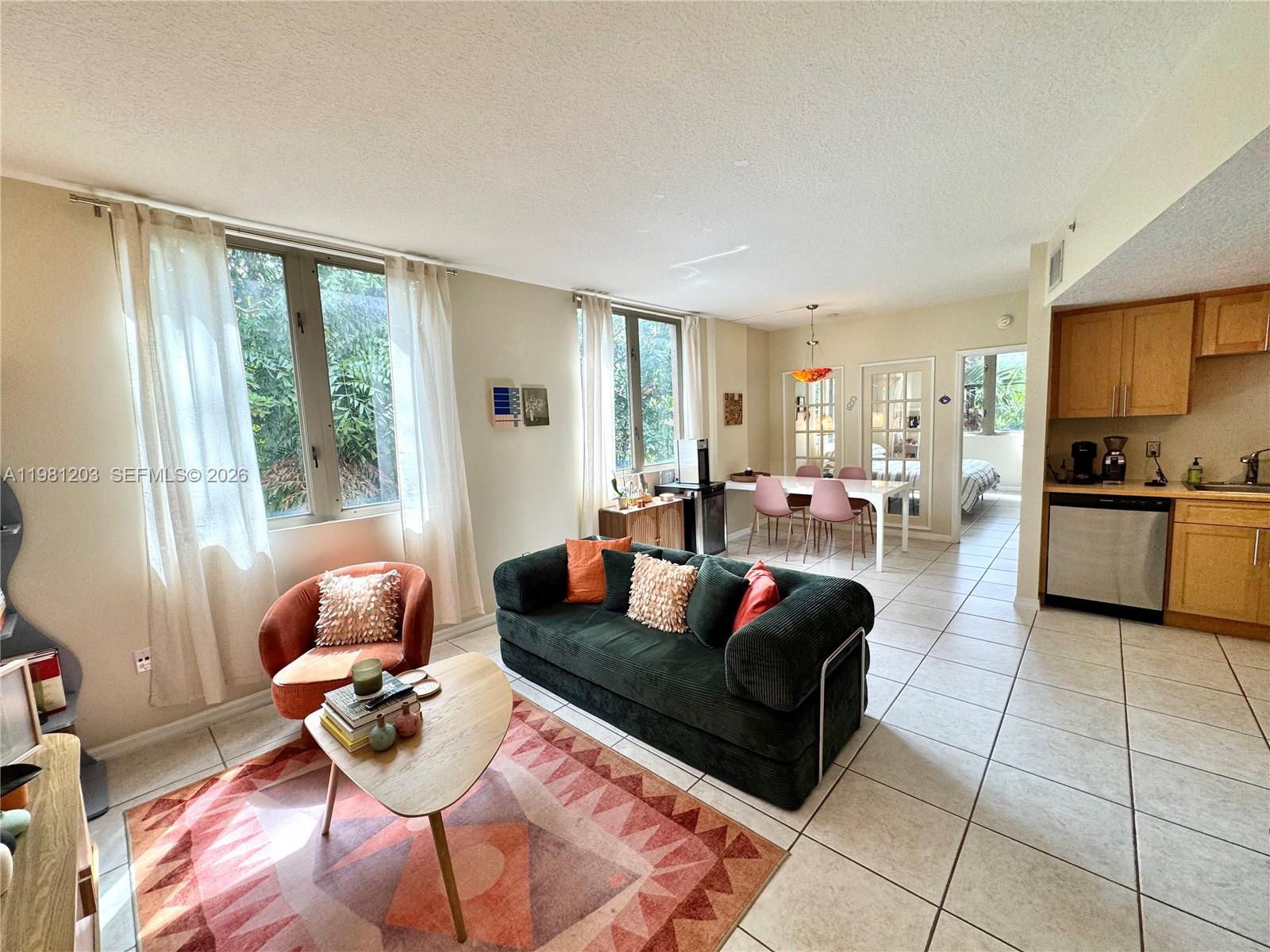2630 Southwest 28th Street, Unit 1 Miami, FL 33133 - Photo 13 of 33 Bright open floor plan with convenience of "powder room" entry from main living area for visiting guests.