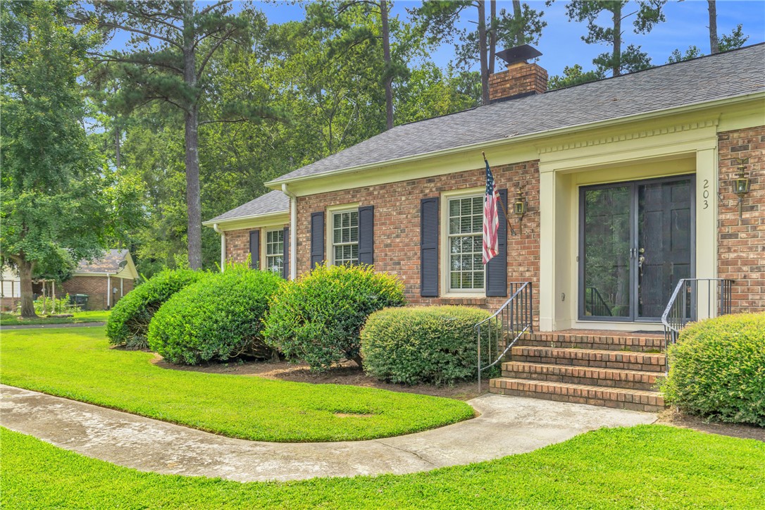 203 Fox Creek Road Anderson, SC 29621 - Photo 2 of 36 This charming brick home features classic shutters and a well-maintained lawn.