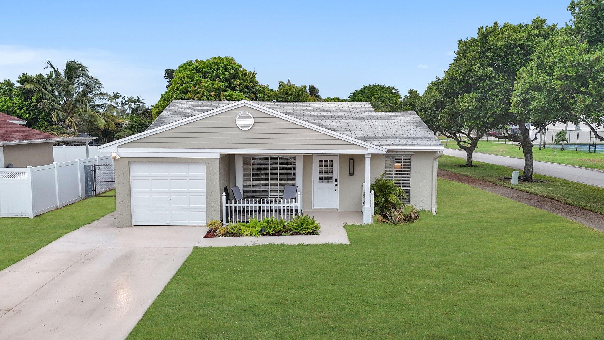 8269 Huntsman Place Boca Raton, FL 33433 - Photo 1 of 42 a front view of a house with a yard and porch