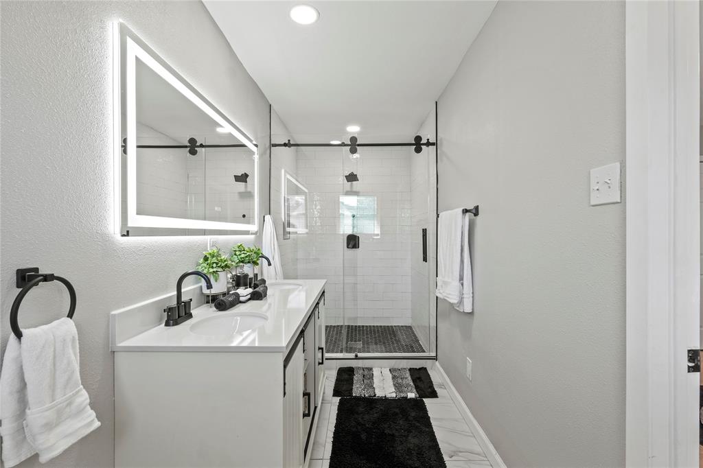 513 East Tyler Street Richardson, TX 75081 - Photo 13 of 18 a bathroom with a sink a toilet and shower