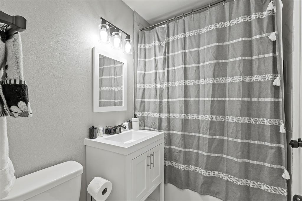 513 East Tyler Street Richardson, TX 75081 - Photo 16 of 18 a bathroom with a sink a toilet and shower