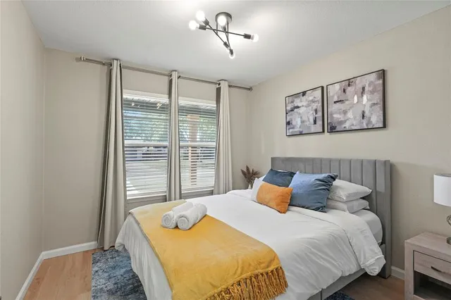 a bedroom with a bed and a window