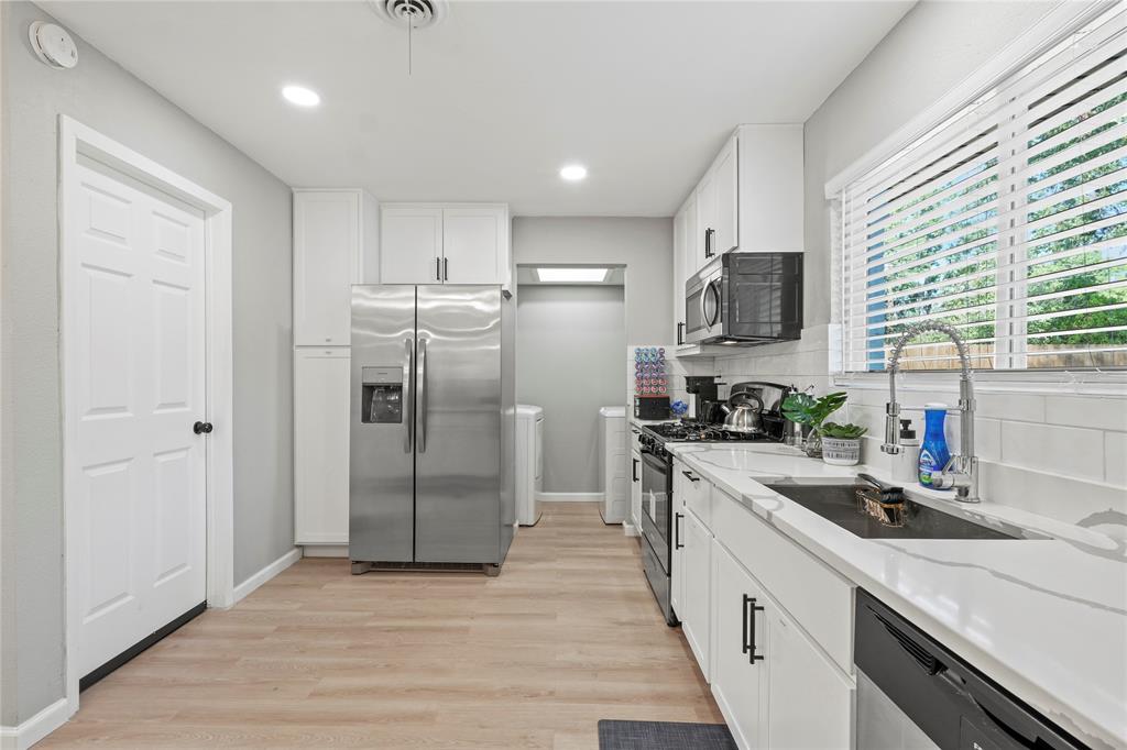 513 East Tyler Street Richardson, TX 75081 - Photo 6 of 18 a kitchen with stainless steel appliances a refrigerator sink and microwave