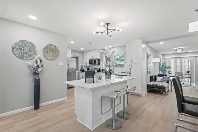 a very nice looking room with kitchen island furniture and a wooden floor