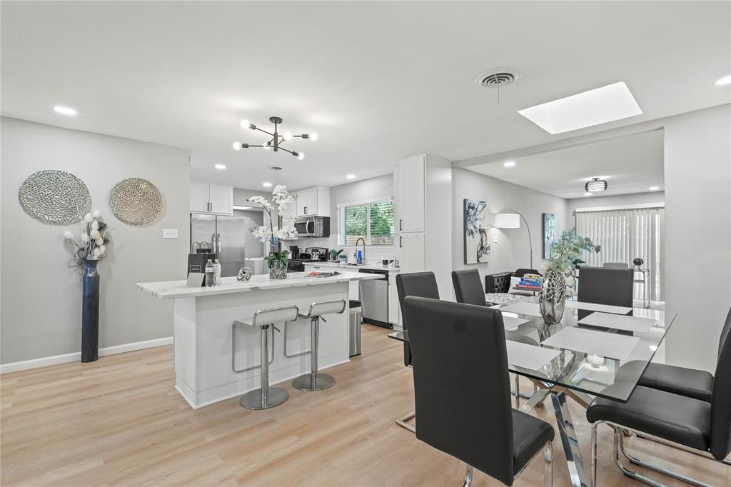513 East Tyler Street Richardson, TX 75081 - Photo 8 of 18 a view of a dining room with furniture and wooden floor