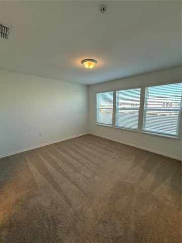 an empty room with a empty space and windows