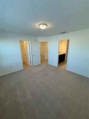 an empty room with windows and closet