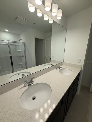 a bathroom with a double vanity sink and a mirror