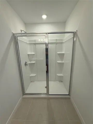 a bathroom with a glass shower door