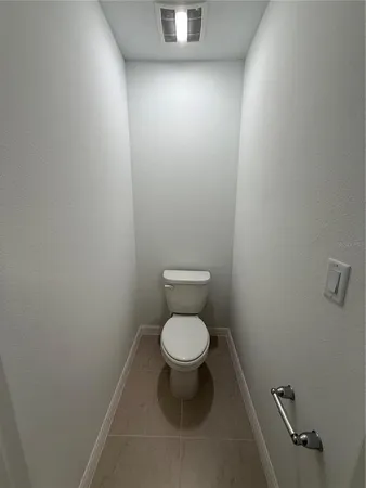 a white toilet sitting in a bathroom