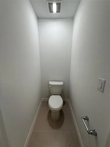 a white toilet sitting in a bathroom