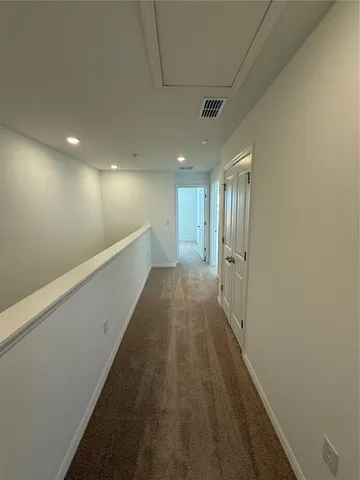 a view of hallway with wooden floor