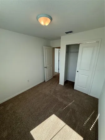 a view of an empty room with windows