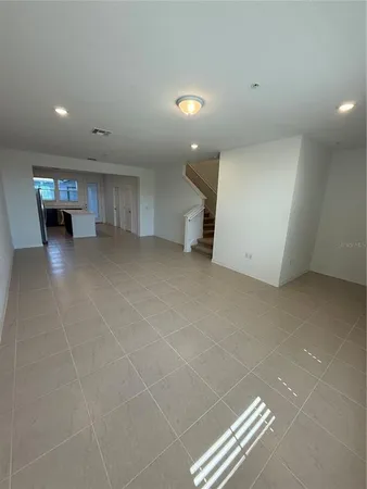 a view of an empty room with stairs