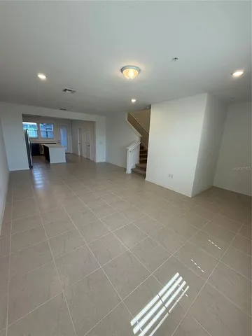 a view of an empty room with stairs