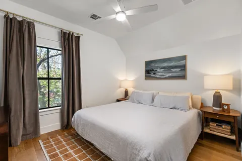 a bedroom with a large bed and a window