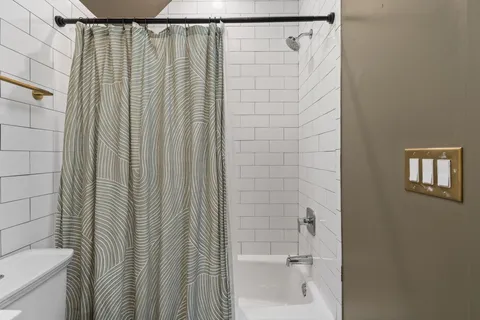 a bathroom with a shower and a toilet