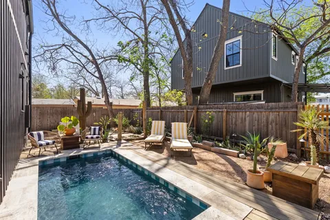 a view of a backyard with sitting area and furniture