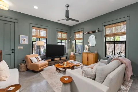 a living room with furniture chess board and a window