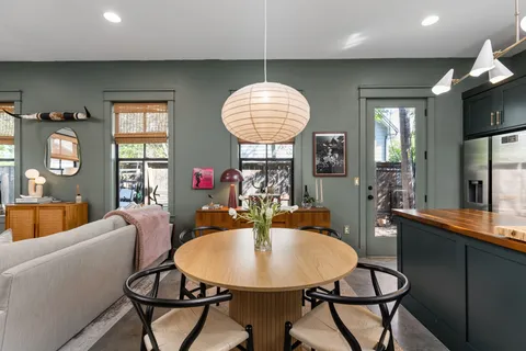 a view of a dining room with furniture and chandelier
