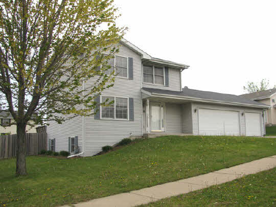 5376 Rockingham Drive Loves Park, IL 61111 - Photo 1 of 11 a front view of a house with a garden
