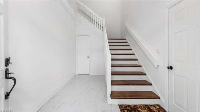 a view of entryway with stairs and white walls