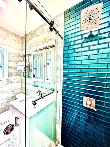 a view of a bathroom with a sink and a shower