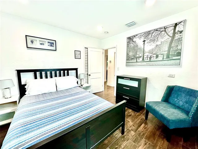 a bedroom with a bed a couch and a window