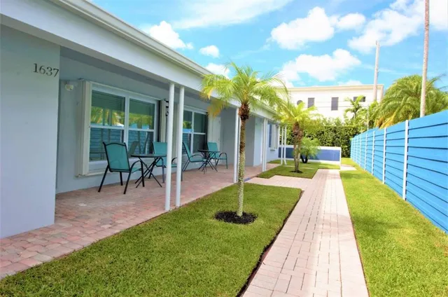 a view of a backyard with sitting area