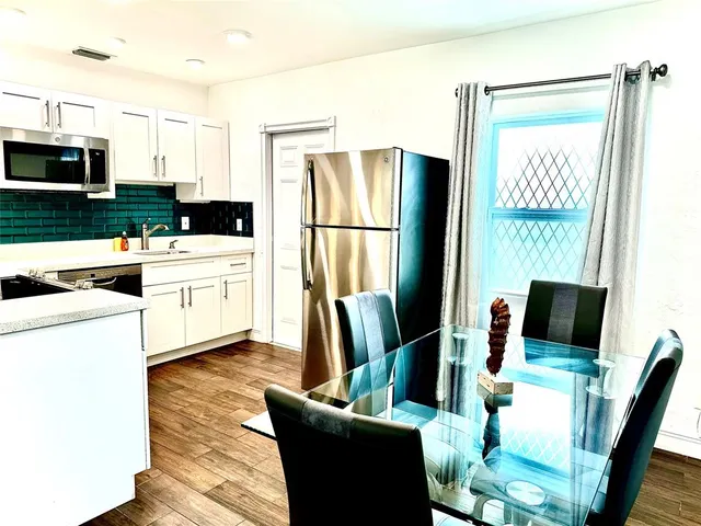a kitchen with stainless steel appliances a refrigerator sink and microwave