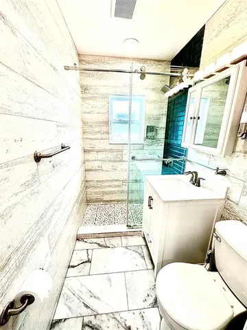 a bathroom with a toilet and a shower
