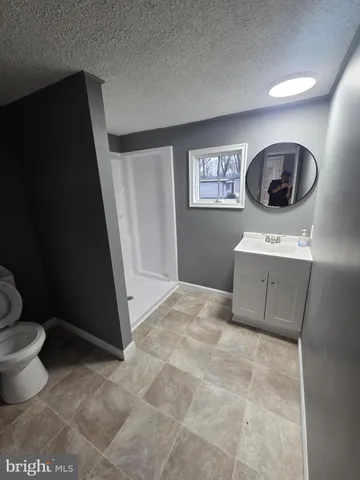 a bathroom with a shower and a window