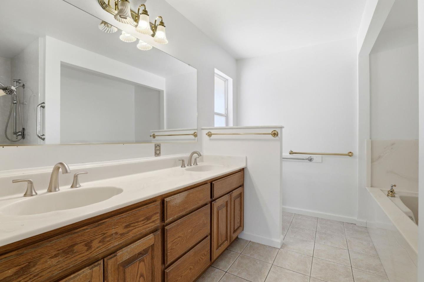 208 Mill Creek Road Fremont, CA 94539 - Photo 25 of 59 a bathroom with a sink a vanity and a mirror