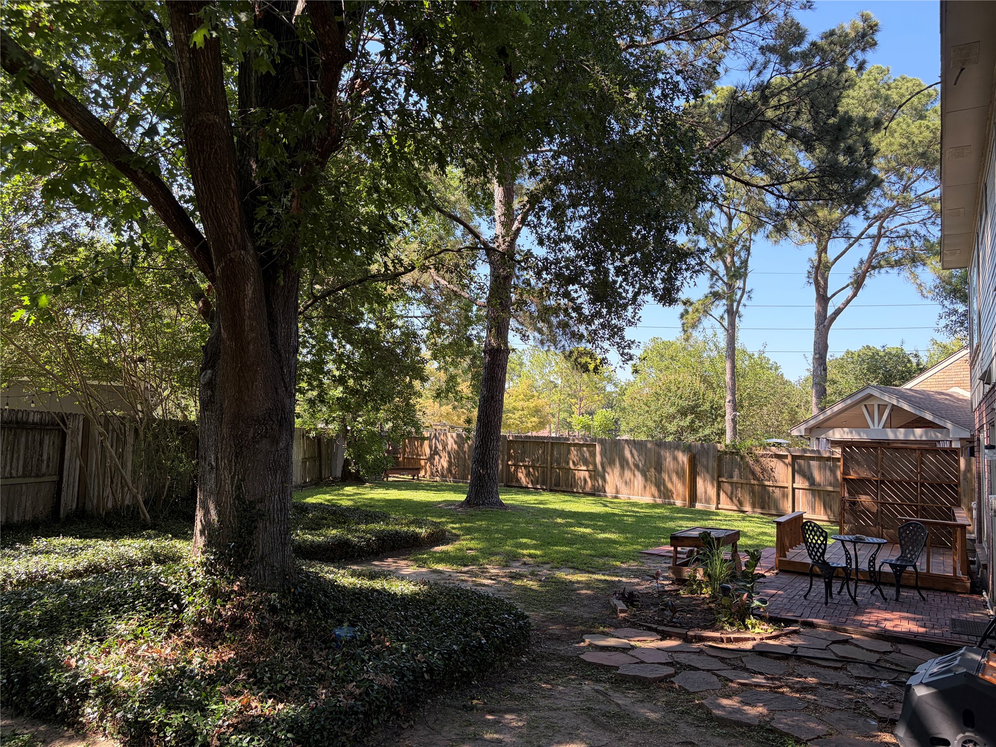 7771 Springville Drive Houston, TX 77095 - Photo 2 of 13 Expansive backyard featuring mature trees and ample outdoor living space.