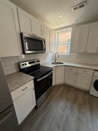 a kitchen with a sink stove and microwave