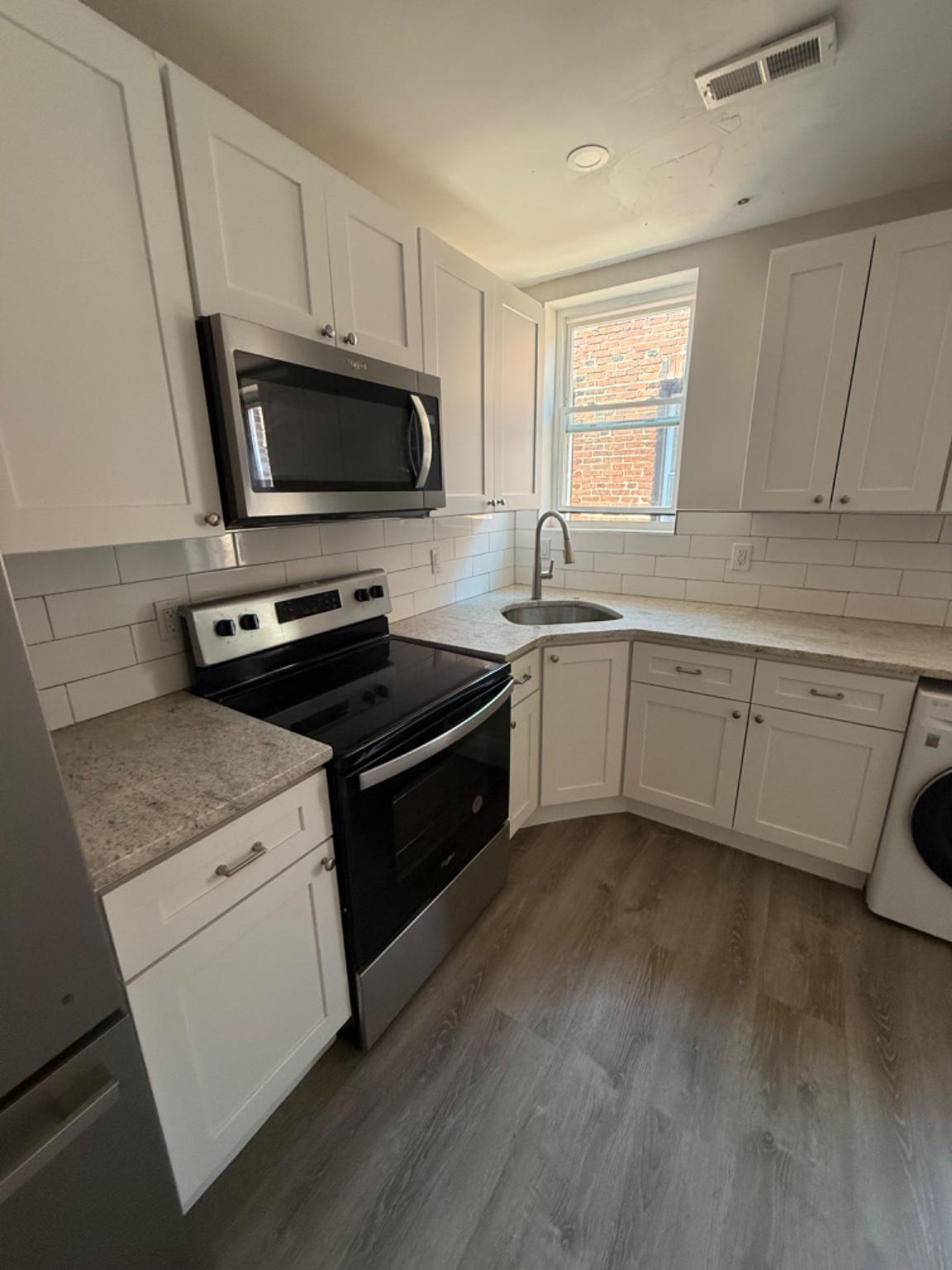 2013 North 63rd Street Philadelphia, PA 19151 - Photo 1 of 13 a kitchen with a sink stove and microwave