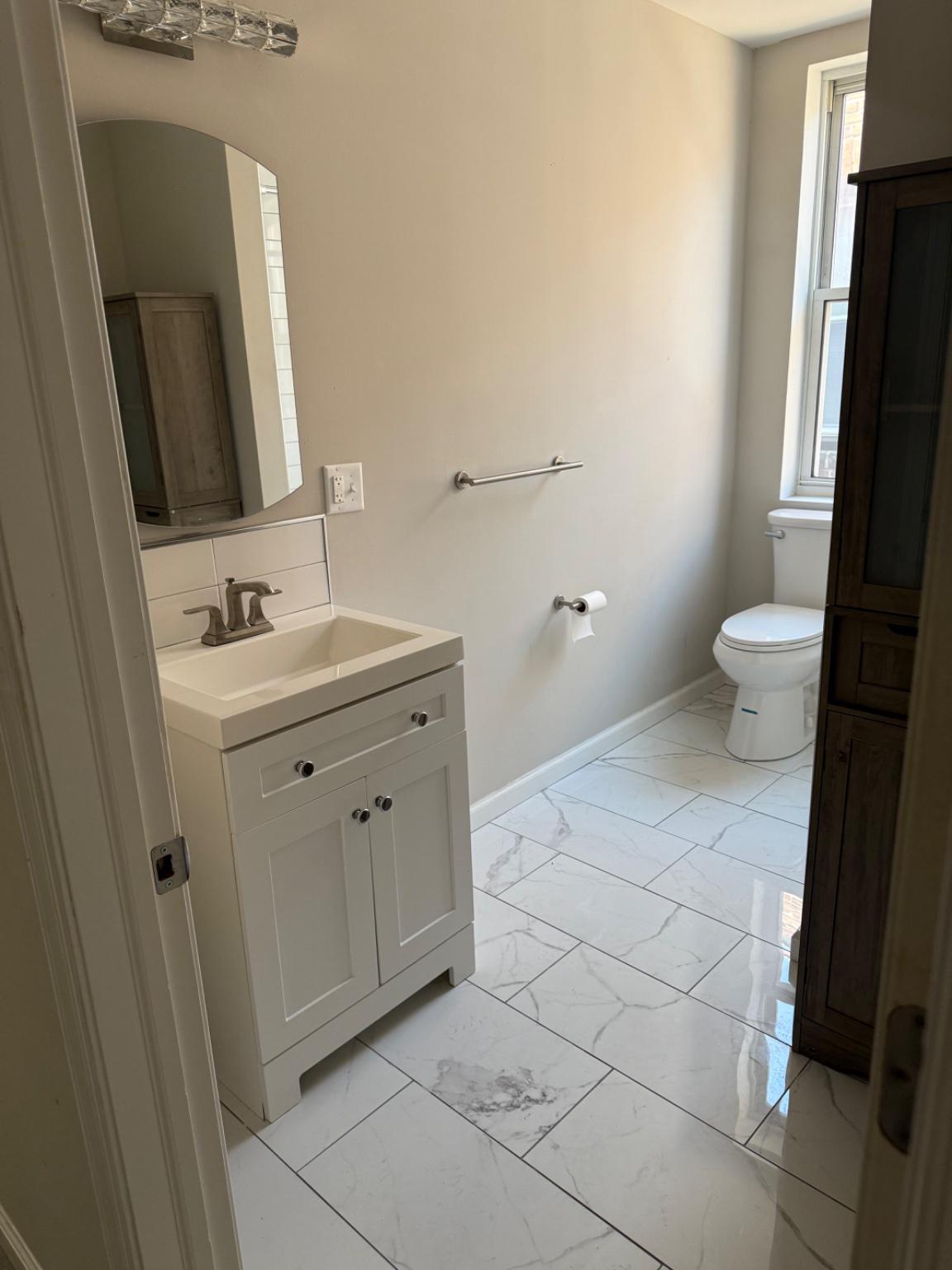 2013 North 63rd Street Philadelphia, PA 19151 - Photo 4 of 13 a bathroom with a sink a toilet and a mirror
