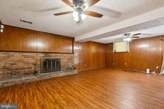 a view of an empty room with a fireplace