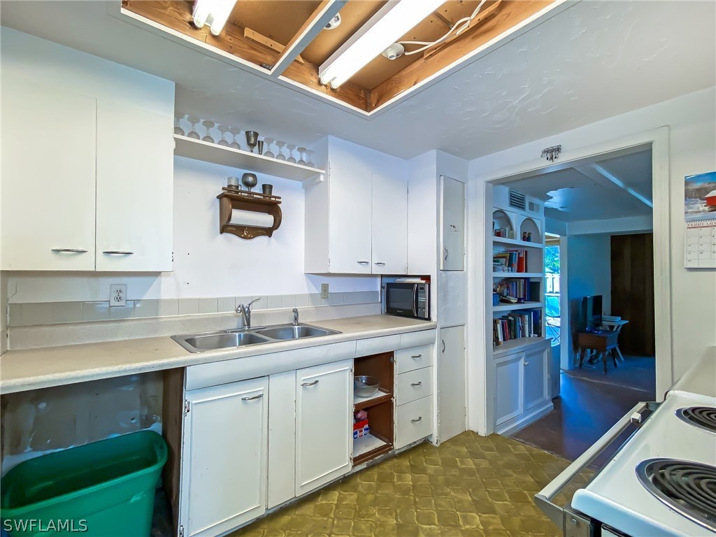 1573 Ransom Street Fort Myers, FL 33901 - Photo 11 of 29 a kitchen with a sink stove and cabinets