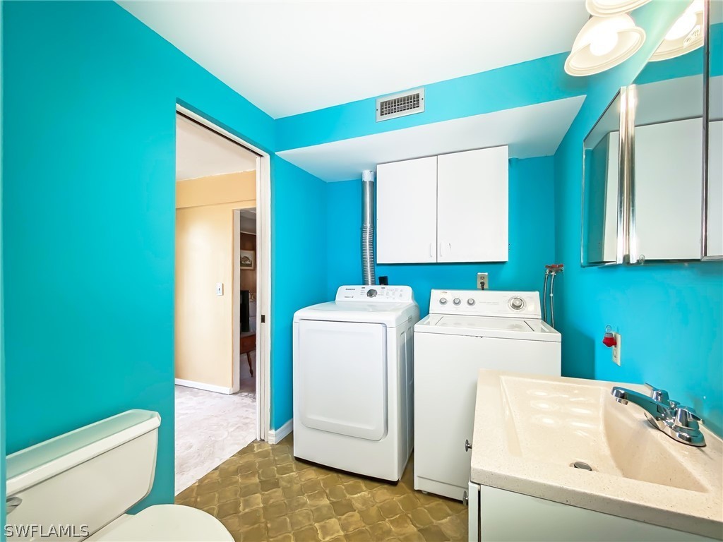 1573 Ransom Street Fort Myers, FL 33901 - Photo 23 of 29 a bathroom with a sink and a washer dryer