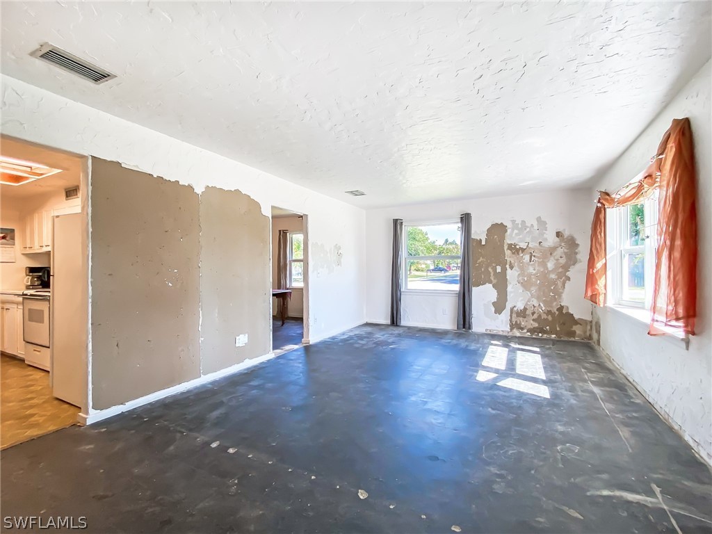 1573 Ransom Street Fort Myers, FL 33901 - Photo 3 of 29 en empty room with windows and wooden floor