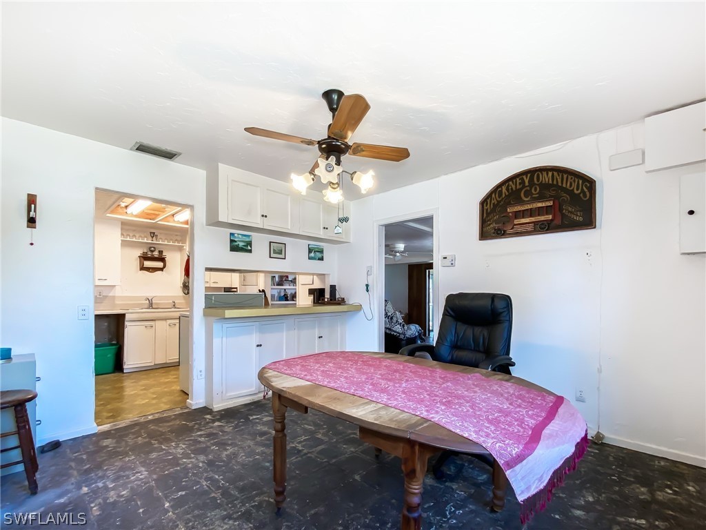 1573 Ransom Street Fort Myers, FL 33901 - Photo 9 of 29 a bedroom with a bed and a chandelier