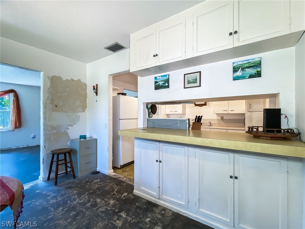 1573 Ransom Street Fort Myers, FL 33901 - Photo 10 of 29 a kitchen with stainless steel appliances granite countertop a refrigerator and a stove