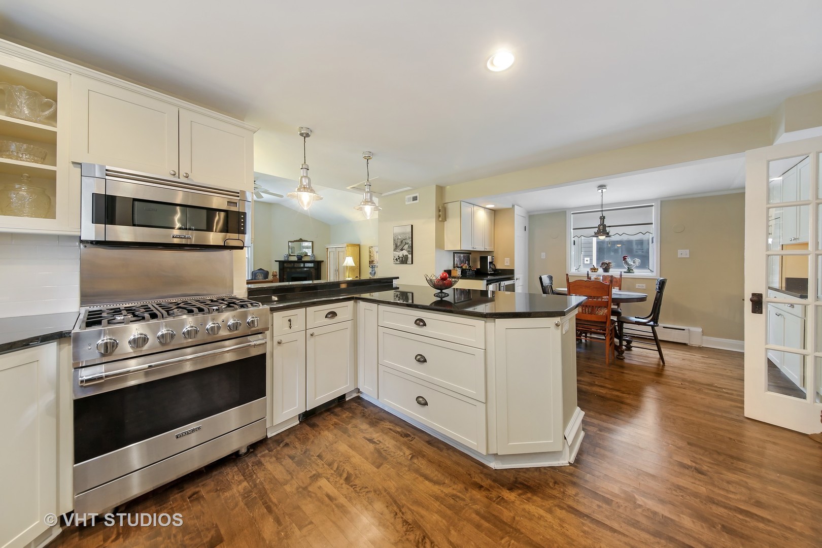 4604 Wolf Road Western Springs, IL 60558 - Photo 4 of 28 a kitchen with stainless steel appliances white cabinets and wooden floors