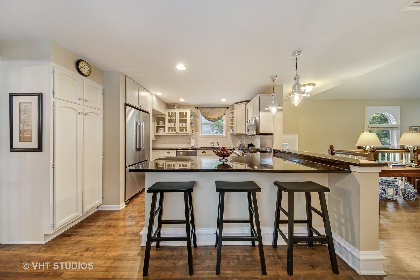 4604 Wolf Road Western Springs, IL 60558 - Photo 5 of 28 a kitchen with stainless steel appliances granite countertop a table chairs stove and refrigerator