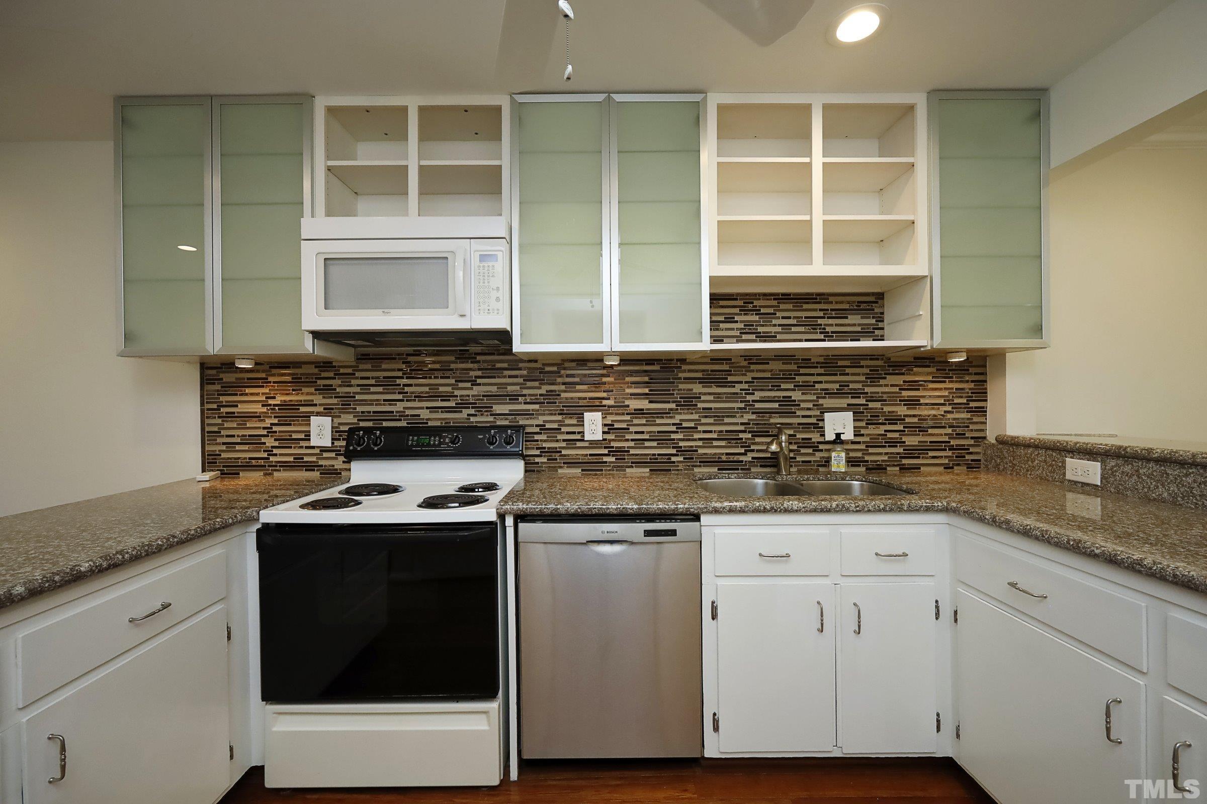 2838 Wycliff Road Raleigh, NC 27607 - Photo 11 of 39 a kitchen with granite countertop a sink stove and cabinets