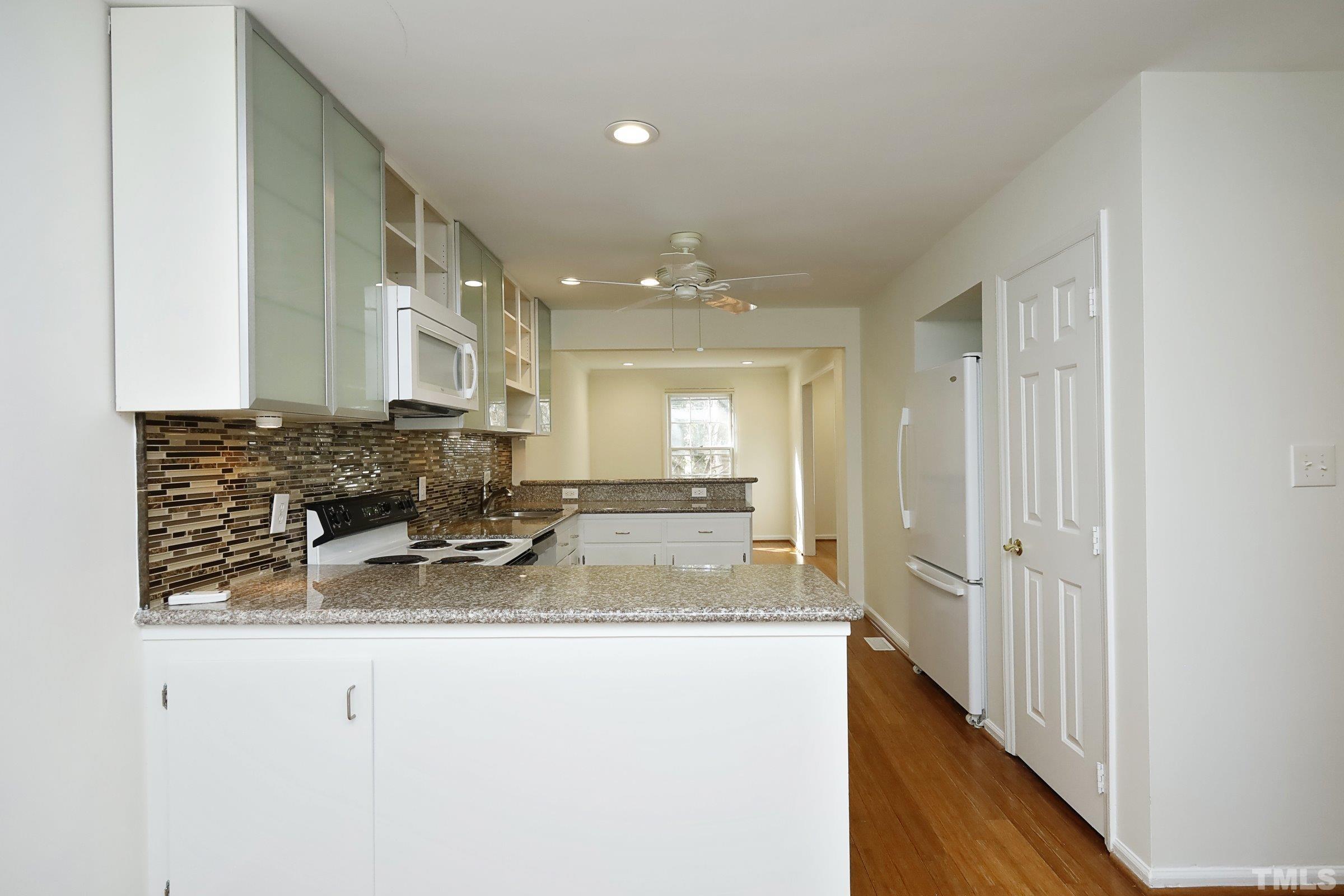 2838 Wycliff Road Raleigh, NC 27607 - Photo 13 of 39 a view of a kitchen with granite countertop a sink and a counter top space